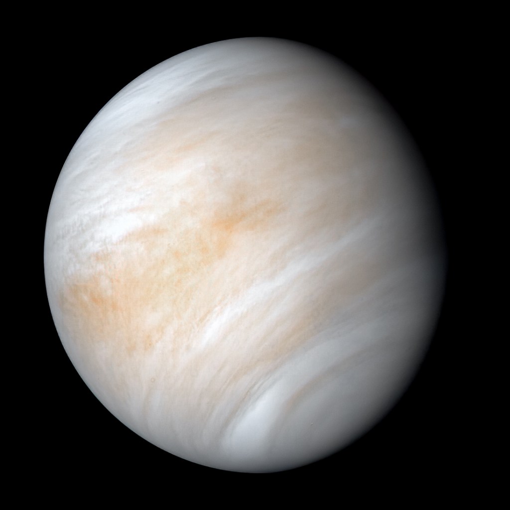 A view of Venus from space, swirled in clouds