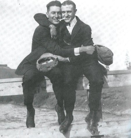 Two men hugging in a black and white photo.