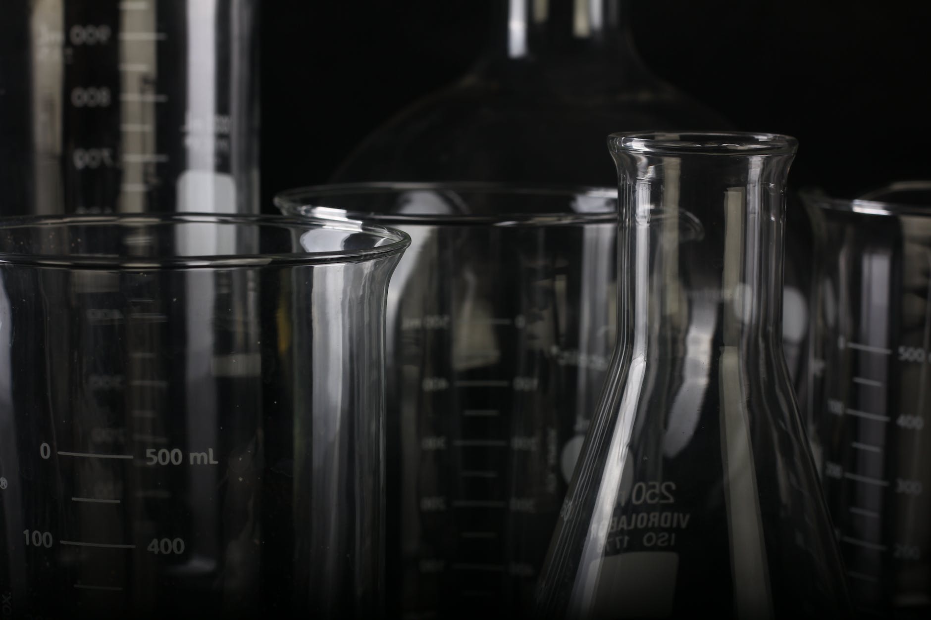 a collection of graduated cylinders and flasks